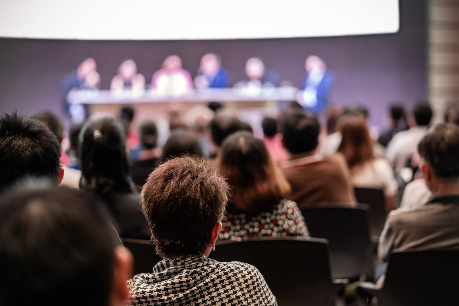 Audience watching a panel of speakers at an innovation conference